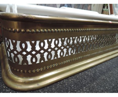A vintage nursery fireguard and brass fender