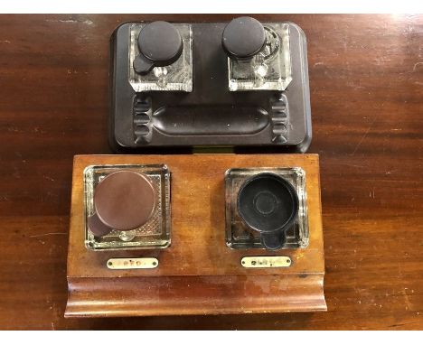 Two sets of ink wells one set mounted in Bakerlite the other light Oak