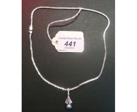 A 14ct white gold necklace with blue pearl pendant.