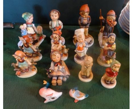 Twelve Goebel figurines, to include: a skier, a girl with a dolls pram, a baker and others, together with two porcelain ducks