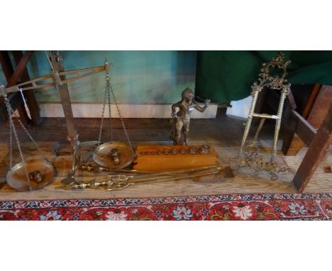 A mixed lot, to include: a pair of brass scales and weights, a brass figure of a boy, fire tools and a brass easel.