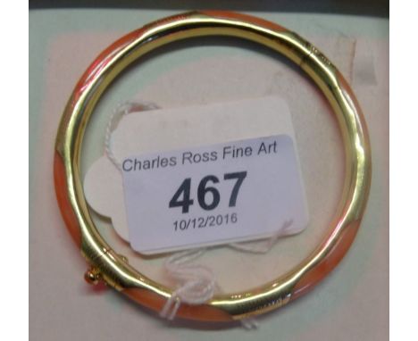 A yellow metal mounted coral bangle, circular with partially engraved mounts, push button clasp to hinged opening, stamped 14