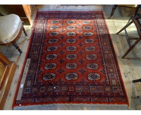 An Eastern carpet, the central rectangular field bordered by repeating geometric shapes (180cm x 134cm). Condition Report: Go