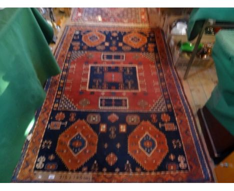 An Eastern-style rectangular carpet with repeating geometric motifs throughout (213cm x 145cm).