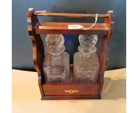 A contemporary two bottle tantalus, to include: decanters and one white metal decanter label (36cm).