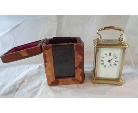 A French gilt brass carriage clock, single barrel movement, five panel bevel edged glass, the enamel dial bearing Roman numer