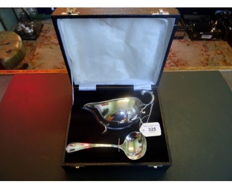 A sterling silver sauce boat and ladle in fitted presentation box.