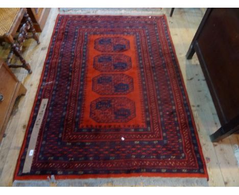 A 20th century Pakistan rectangular carpet, the central field with four geometric lozenges (187cm x 134cm). Condition Report: