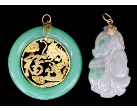 A modern carved jade pendant depicting a cherry, 44mm x 25mm, the mount marked as 18ct gold, and a circular jade pendant, 44m