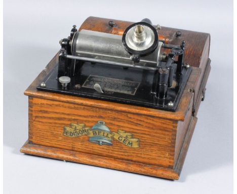 An early 20th Century Edison Bell "Gem" phonograph No. 22865, contained in oak case with domed cover and turned wood handle, 