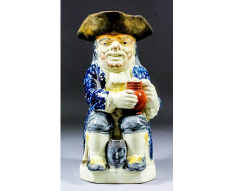 An early 19th Century Staffordshire pottery "bearded" Toby jug of Wood type, with pipe, barrel and foaming jug of ale, with s