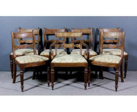 A set of seven George III mahogany dining chairs (including one armchair with scroll arms), the narrow panelled crest rails w