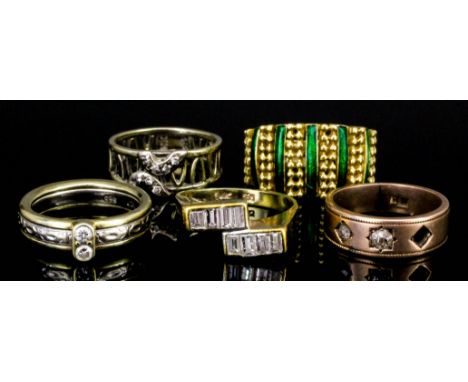 A modern 14k yellow and white gold band ring, the centre panel of textured design and the face set with two small diamonds (s