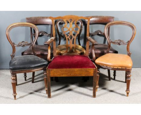 A pair of early Victorian mahogany dining chairs with plain curved crest rails and scroll carved splats, the drop-in seats up