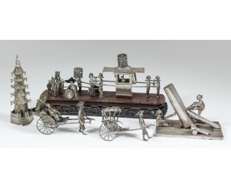 Five Chinese silvery metal toys, including - a procession of figures with a figure in a sedan chair, on hardwood rectangular 