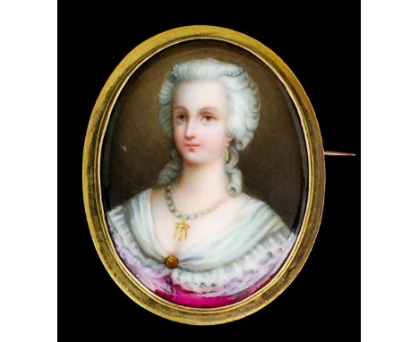 A late 19th Century gold coloured metal mounted oval brooch, set with painted porcelain miniature portrait of a lady in 18th 