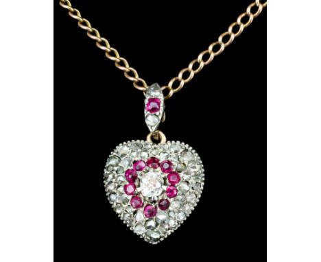 A late 18th Century gold coloured metal mounted ruby and diamond set heart-shaped pendant, set with old cut diamonds, the cen