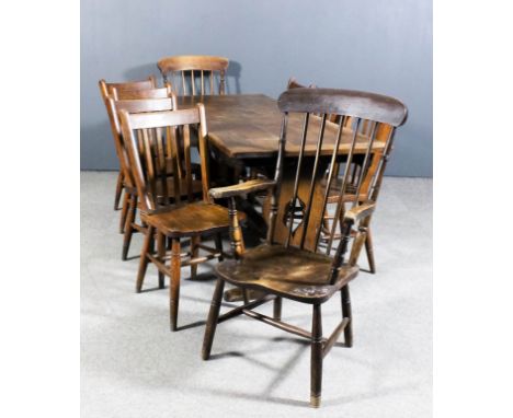 An oak refectory table with cleated five plank top, on fretted shaped end supports and trestle feet, 71ins x 28.5ins x 29.5in