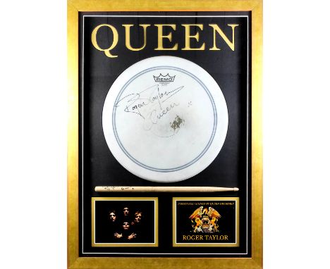 An autographed drum skin and drum stick signed by Queen drummer Roger Taylor, contained in display frame, 29.5ins x 21.5ins, 