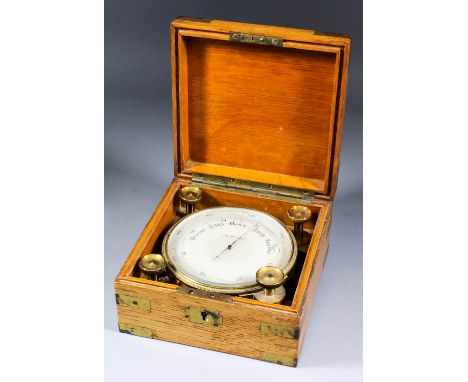 An early 20th Century lacquered brass cased cylindrical aneroid barometer with silvered scale and adjustable outer scale, 5in