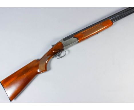 A good 12 bore over and under shotgun by Hilton, Serial No. 11082, the 28 ins blued steel barrels with raised top rib, bright