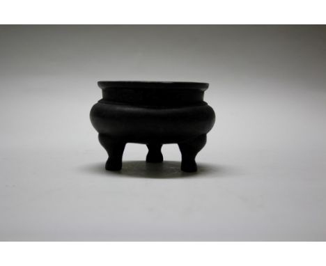 A Chinese bronze tripod censor, Xuande six character mark, 12cm diameter, 1205g. Condition Report: Both handles missing.