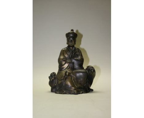 An interesting Chinese bronze figure of a Taoist, possibly Ming, seated on a mythical beast, 27cm high.