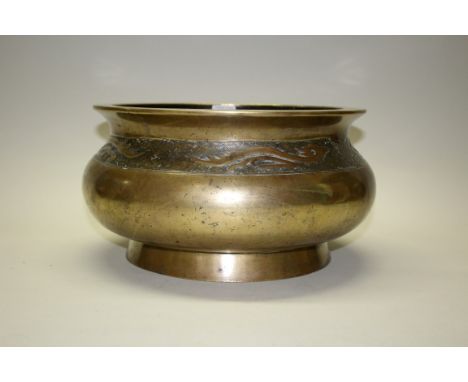 A very large Chinese bronze circular censer, Xuande six character mark, decorated with a continuous band of stylized dragons,