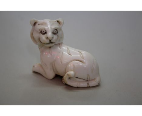 A Japanese carved ivory netsuke of a tiger, Meiji period, signed, 4.4cm long.Provenance: Martyn R Bagley, 1st February 1996.