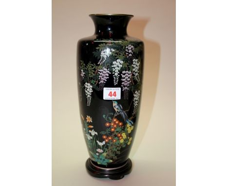 A Japanese cloisonne enamel vase, mark of Ota Kichisarubo, decorated with a bird and flowering branches, 30.5cm high, on wood