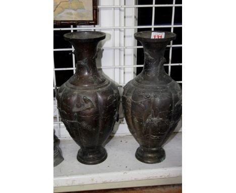 A pair of Japanese bronze vases, Meiji period, of lobed form, relief decorated with birds, 31.5cm high. (2)