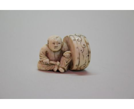 A Japanese carved ivory netsuke of a boy and drum, signed Shiko, 19th century, 3cm high.Provenance: Martyn R Bagley, 3rd Febr