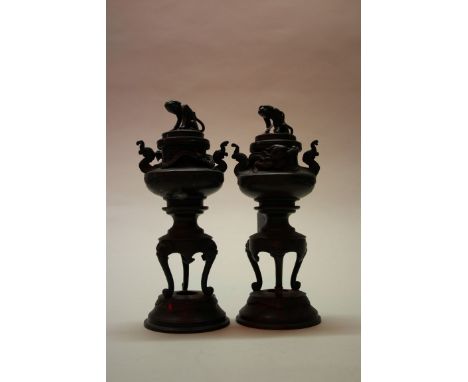 A pair of Chinese bronze twin handled censers and covers, 21.5cm high.