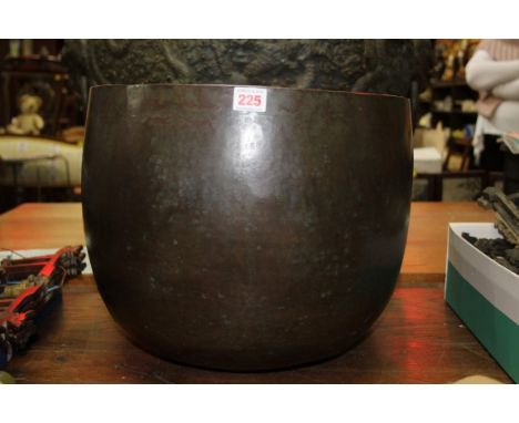A large Sino-Tibetan bronze singing bowl, possibly 18th century, inscribed to rim in three places, 32cm high x 40cm diameter.
