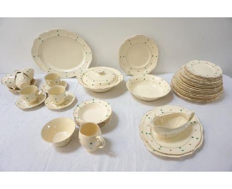 BRITISH DINNER AND COFFEE SERVICEdecorated with a cream ground and gilt borders with green and gilt spots comprising six cups