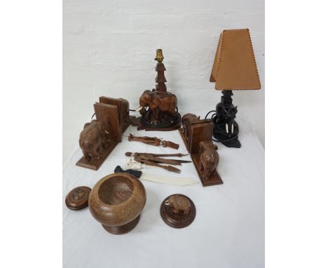 ANIMAL INTERESTtwo pairs of carved elephant bookends, a carved elephant lamp and a carved ebonised elephant lamp, a carved bo