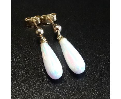 PAIR OF OPAL DROP EARRINGSthe teardrop shaped opals in unmarked gold mounts 