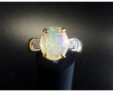 ETHIOPIAN OPAL AND DIAMOND DRESS RINGthe large oval brilliant cut opal with Gem Collector certificate stating the weight as 1