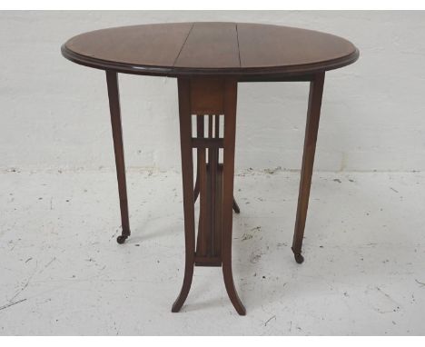 EDWARDIAN MAHOGANY AND INLAID SUTHERLAND TABLEwith shaped drop flaps, standing on shaped supports with gate legs and porcelai