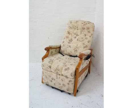 ELECTRIC RISE AND RECLINE ARMCHAIRwith a light oak frame and floral fabric, on castors 