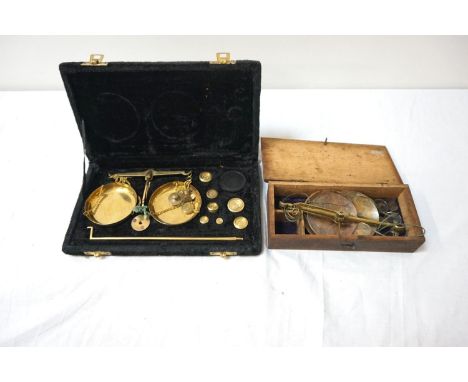CASED TRAVELLING SET OF SCALESin a fitted case, the brass scales with various weights; together with another similar in woode