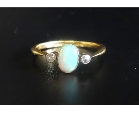 OPAL AND DIAMOND THREE STONE RINGthe central oval opal flanked by diamonds, on eighteen carat gold shank, ring size K-L 