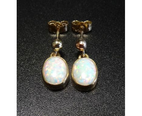 PAIR OF OVAL CABOCHON OPAL DROP EARRINGSin nine carat gold 