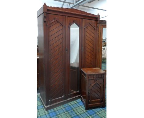 AESTHETIC MOVEMENT PITCH PINE WARDROBEwith Christopher Dresser style detail, with a shaped carved cornice above a central pil