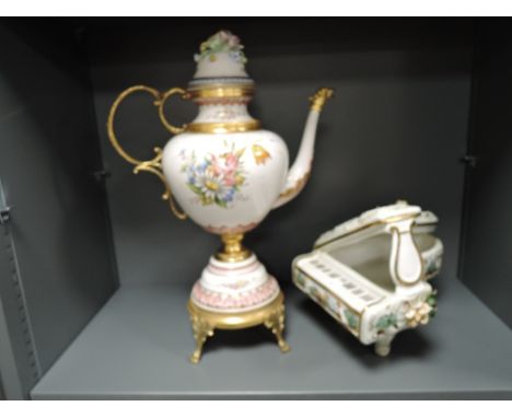 A large Italian decorative ewer or teapot in a Capodimonte style and a similar piano model