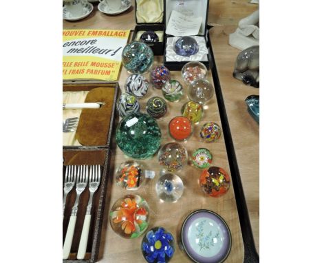 A collection of paperweights including Caithness.