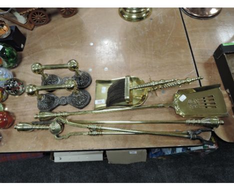 A selection of vintage brass fireside items including brush, shovel and poker.