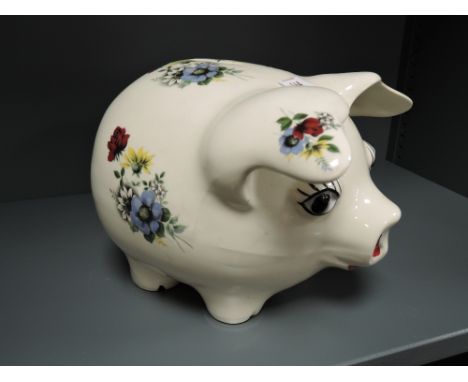 A large ceramic piggy bank having transfer print design