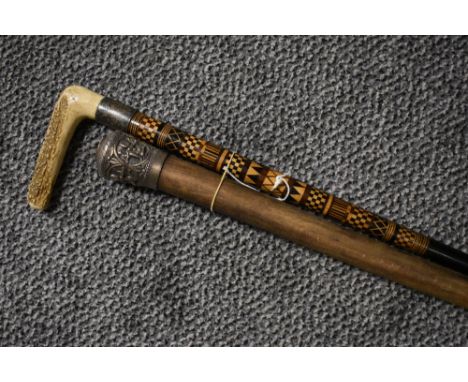 An antique silver topped Burmese walking cane and a similar horn handle walking stick