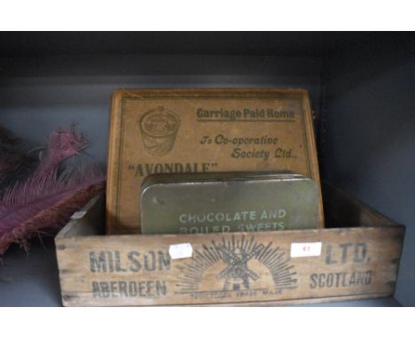 A selection of vintage advertising boxes including wooden crate
